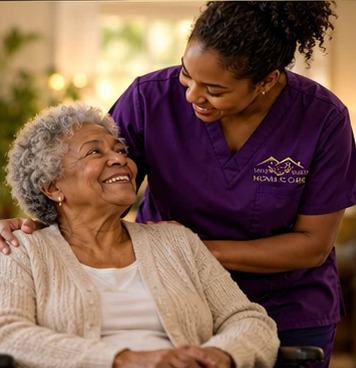 A Safe Haven caregiver in purple scrubs smiling with an elderly client